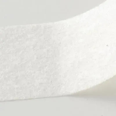 Close-up of white NON-WOVEN TAPE lash strip on a smooth surface