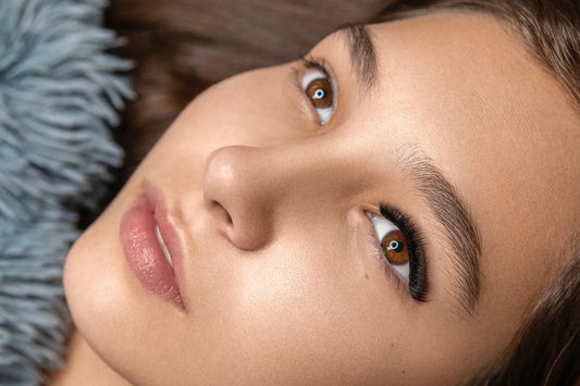 Close-up of a woman's face showcasing fluffy russian volume lashes
